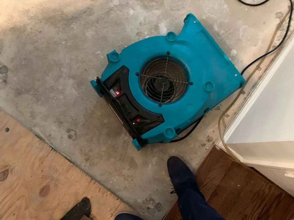 Air mover drying subfloor during Leak Detection & Repair in Rose Hill